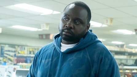 Brian Tyree Henry as Paper Boi in blue hoodie inside brightly lit convenience store in FX's Atlanta