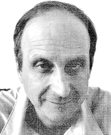 Kerry Orent headshot wearing a collar shirt and leaning forward