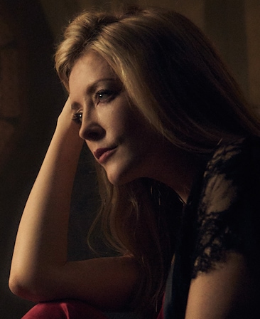 Jennifer Finnigan headshot with her arm up and hand on her head