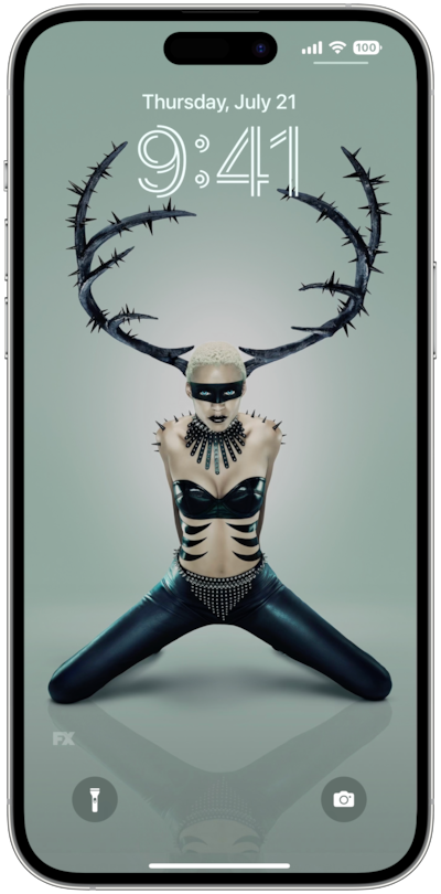 iPhone lock screen of person wearing black antlers with knees stretched in black pants for FX'S AHS NYC