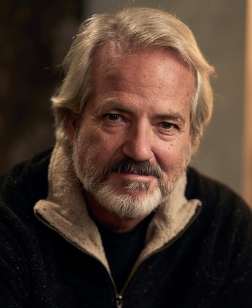 Graham Yost headshot wearing a black jacket.