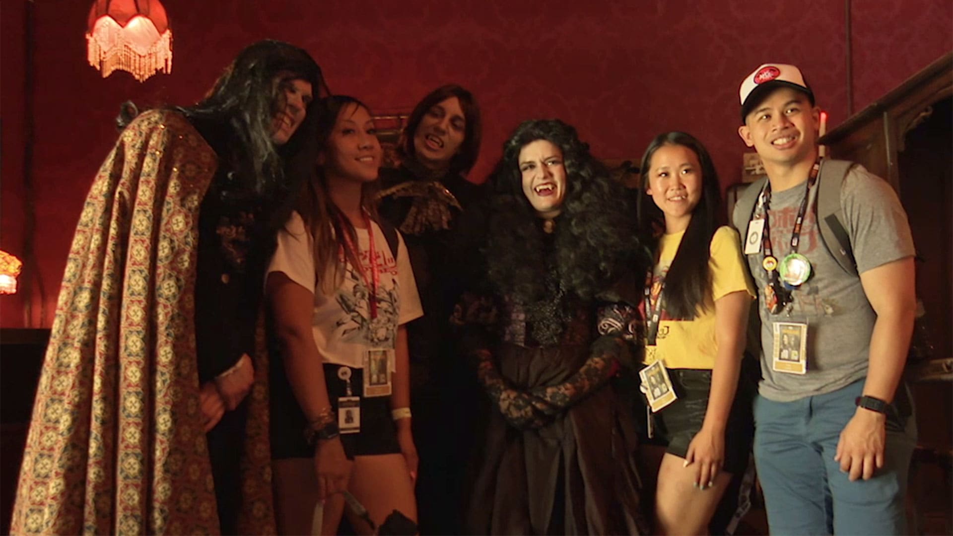 People dressed up as the What We Do in the Shadows cast smiling for a picture