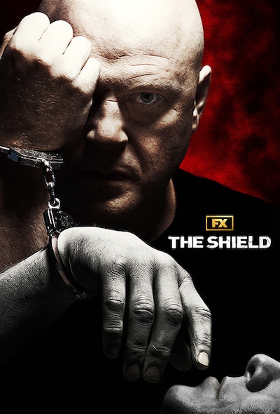 Man covering one eye while handcuffed to another man for FX's The Shield