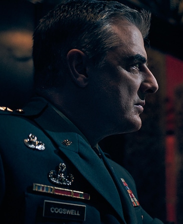 Chris Noth headshot wearing a jacket with a name tag that read "cogswell"