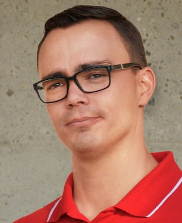 Diego Sheldon Gonzalez headshot in a red collared shirt and black square shaped glasses from FX's Necaxa.