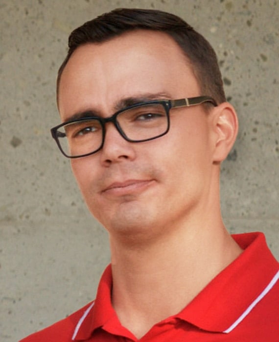 Diego Sheldon Gonzalez headshot in a red collared shirt and black square shaped glasses from FX's Necaxa.