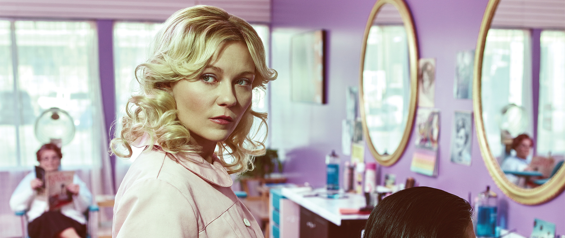 Kirsten Dunst as Peggy cutting customer's hair in a salon
