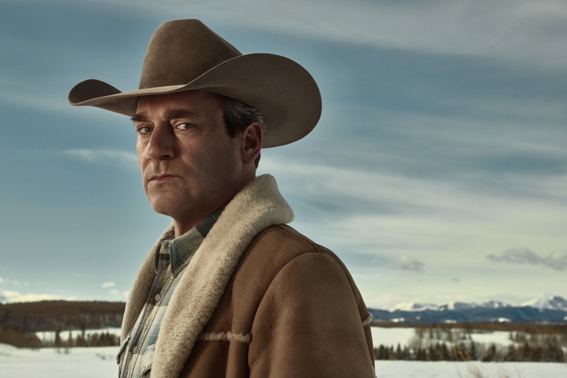 Roy Tillman outside wearing cowboy hat and jacket starring into the camera.