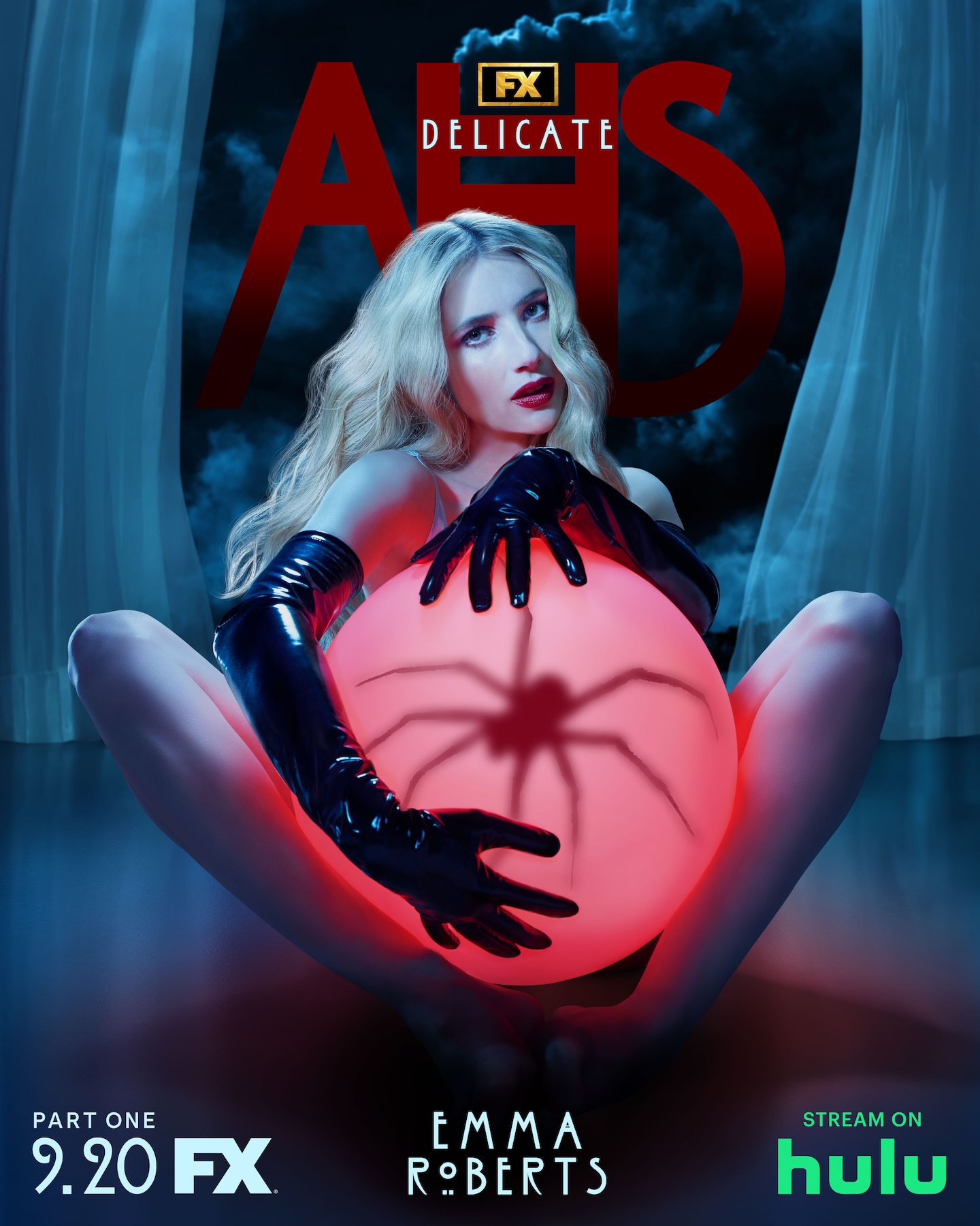 Blonde haired woman with long black leather gloves holds a red glowing orb with a spider inside for AHS: Delicate