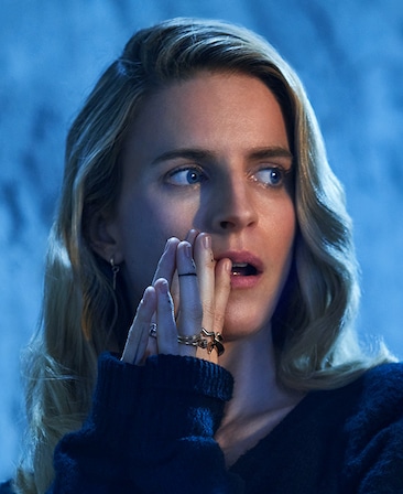 Brit Marling headshot wearing rings on her fingers and a black sweater
