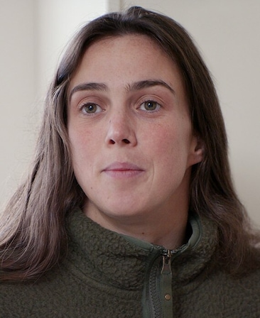 Rosie Hughes headshot wearing a green zip up sherpa jacket