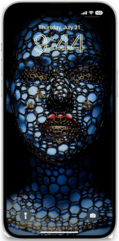 iPhone lock screen of blue woman with red lipstick covered in honeycomb pattern net and bees from FX's AHS Cult