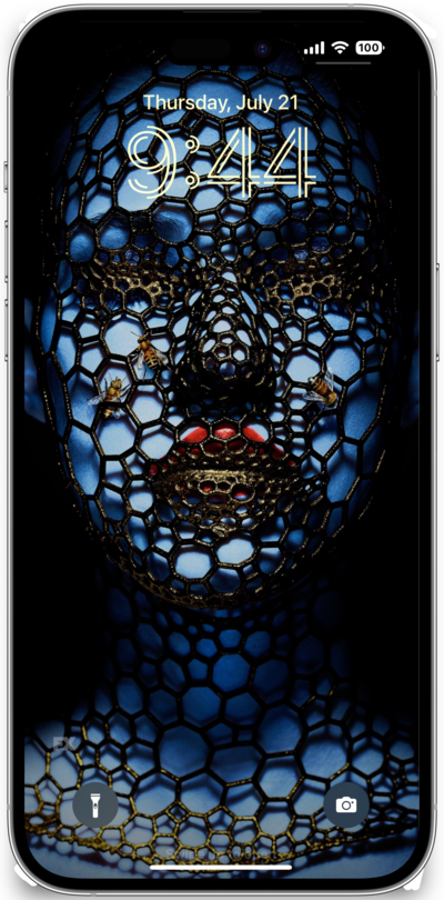 iPhone lock screen of blue woman with red lipstick covered in honeycomb pattern net and bees from FX's AHS Cult
