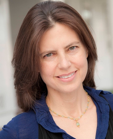 Sarah Timberman headshot wearing a navy top and necklace.