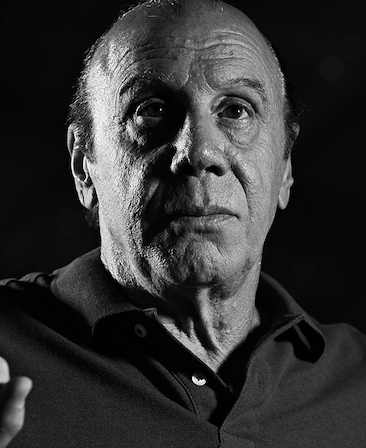 Dayton Callie headshot wearing a polo shirt, in a black and white effect