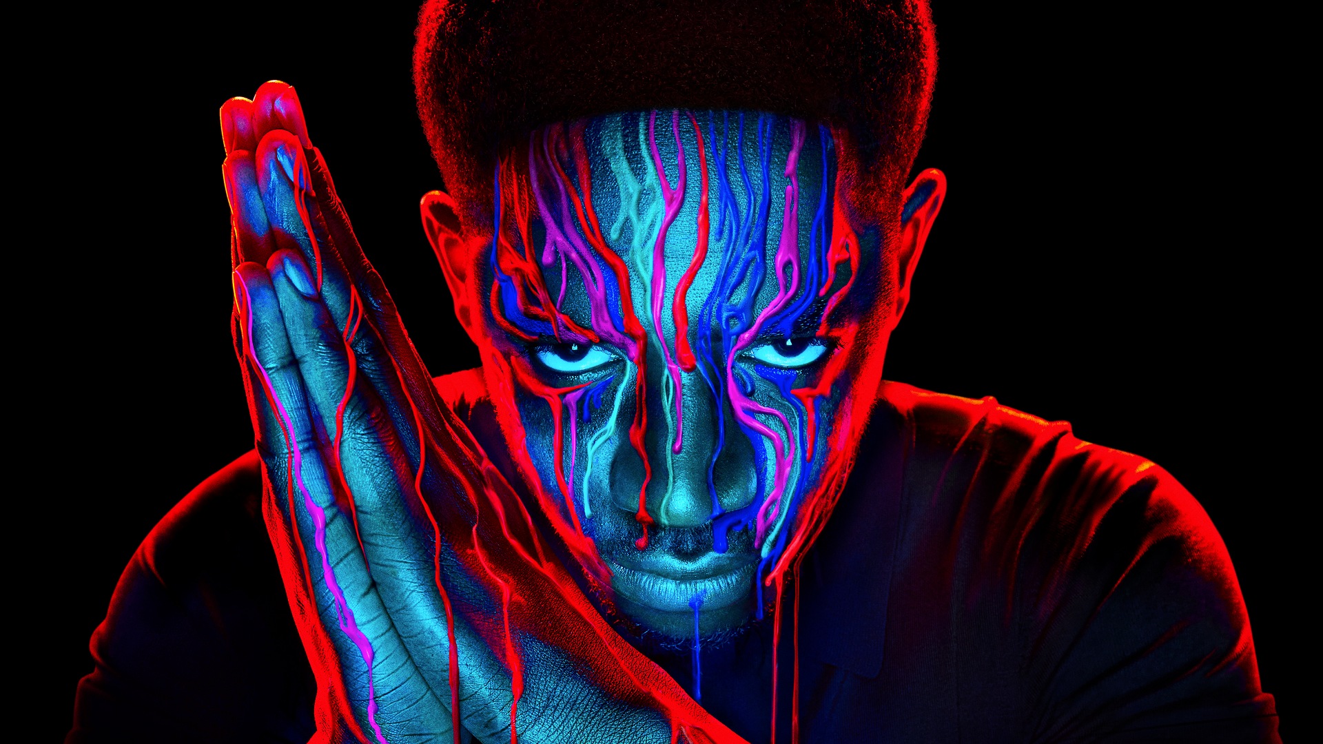 Damson Idris with red and blue paint dripping down in Snowfall his face