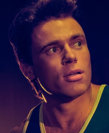 Gus Kenworthy filtered headshot in green tank top with light shining on face from American Horror Story 1984