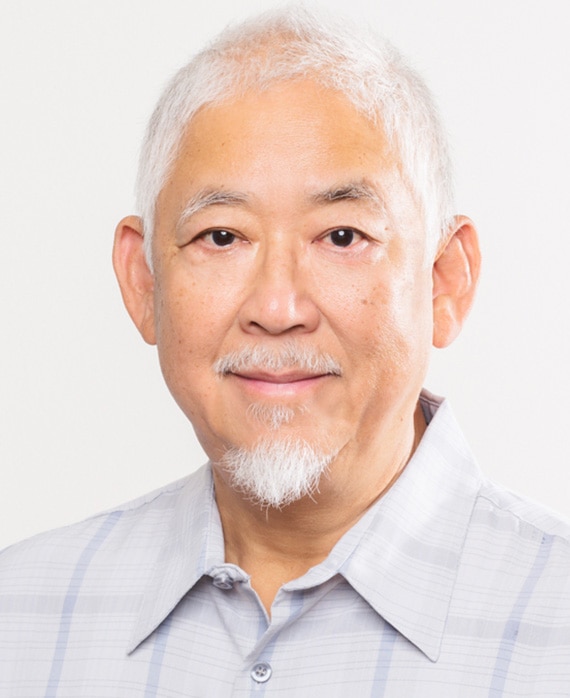 Victor Hsu headshot wearing a gray plaid collar shirt