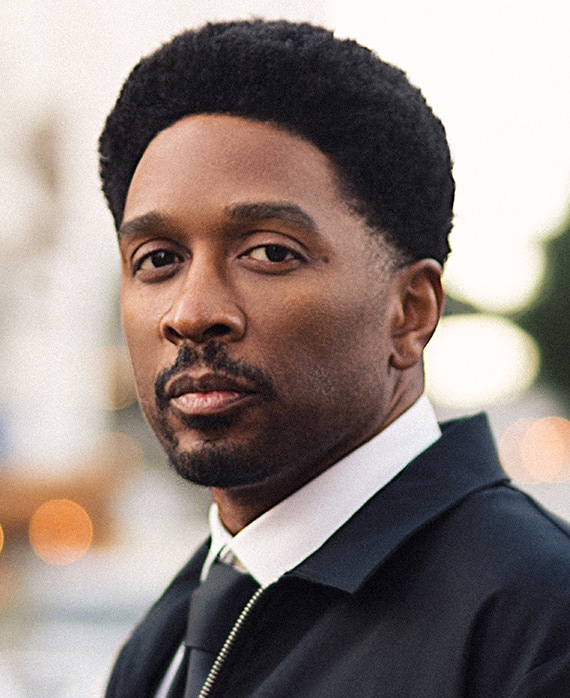 Headshot of Joe Robert Cole wearing a suit for FX's Class of 09