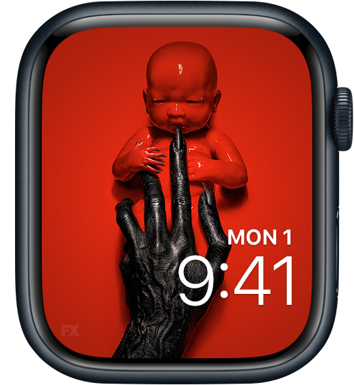 Apple Watch lock screen of red baby with black claws held by black hands American Horror Story 8 Apocalypse