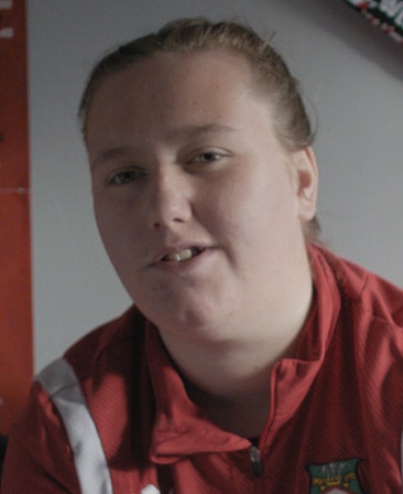 Millie Tipping wearing a red and white jersey with the Wrexham logo on it