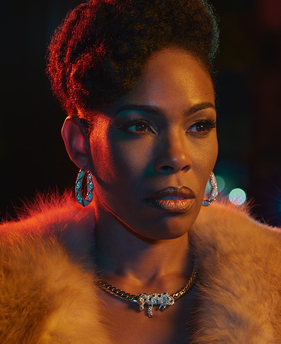 Angela Lewis headshot wearing a fur coat and statement jewelry