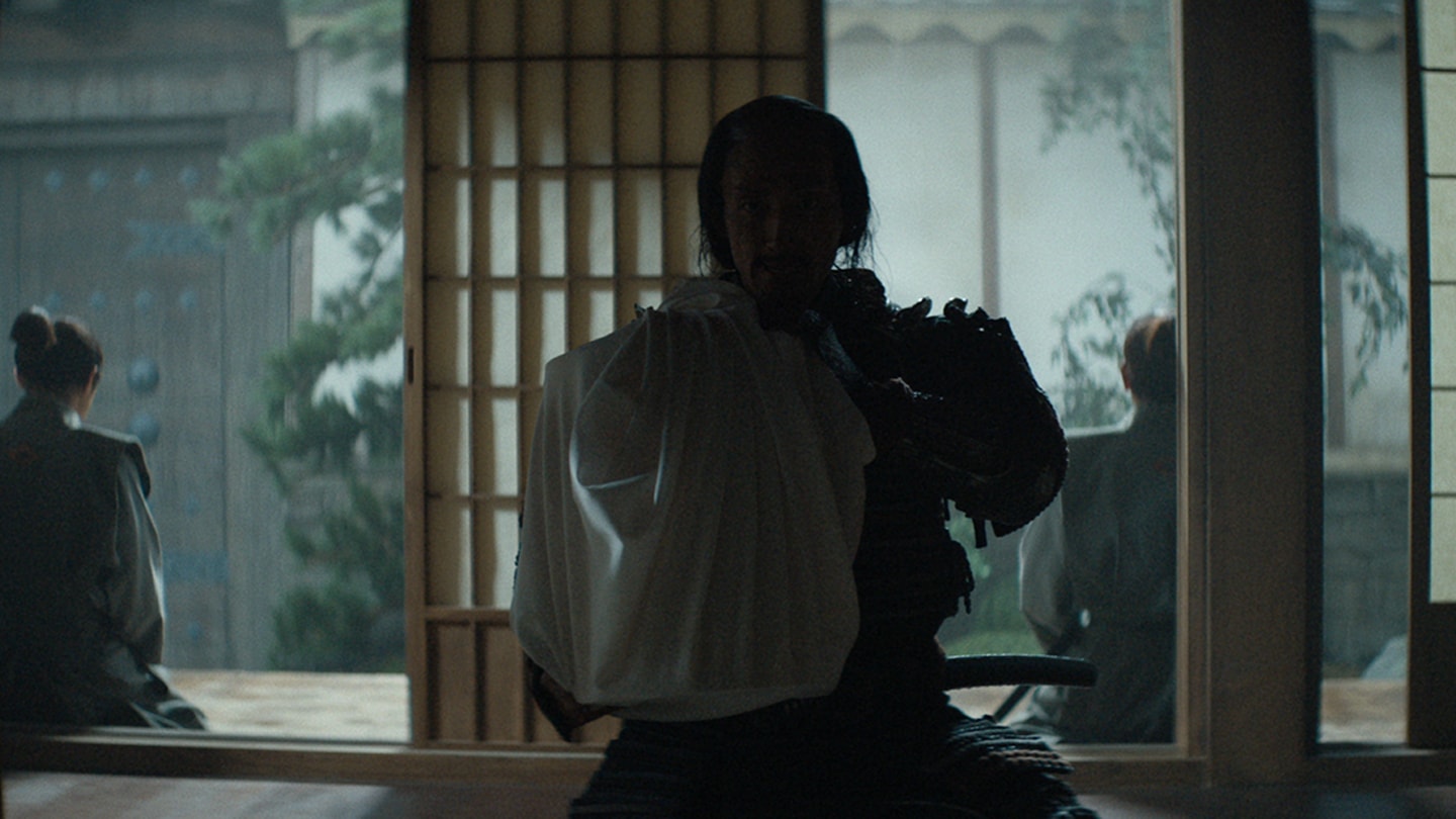 An armored samurai delivers a head in a wooden box covered by white fabric