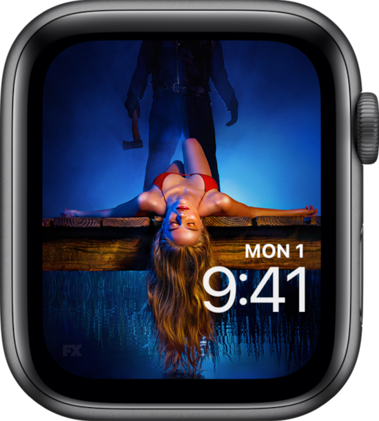 Apple Watch with lock screen of woman in red bikini laying down on lake deck with man holding axe behind her