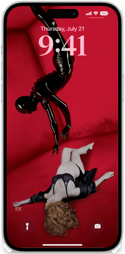 iPhone lock screen of pregnant woman on red floor in black lingerie with rubber man reaching toward her for AHS Murder House