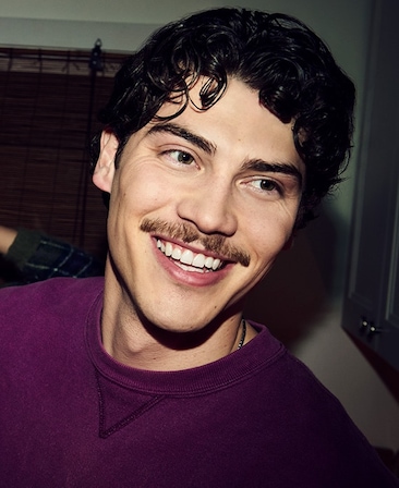 Headshot of Jack Innanen as Paul Baker in FX's Adults, wearing a purple long sleeve and necklace tucked under.