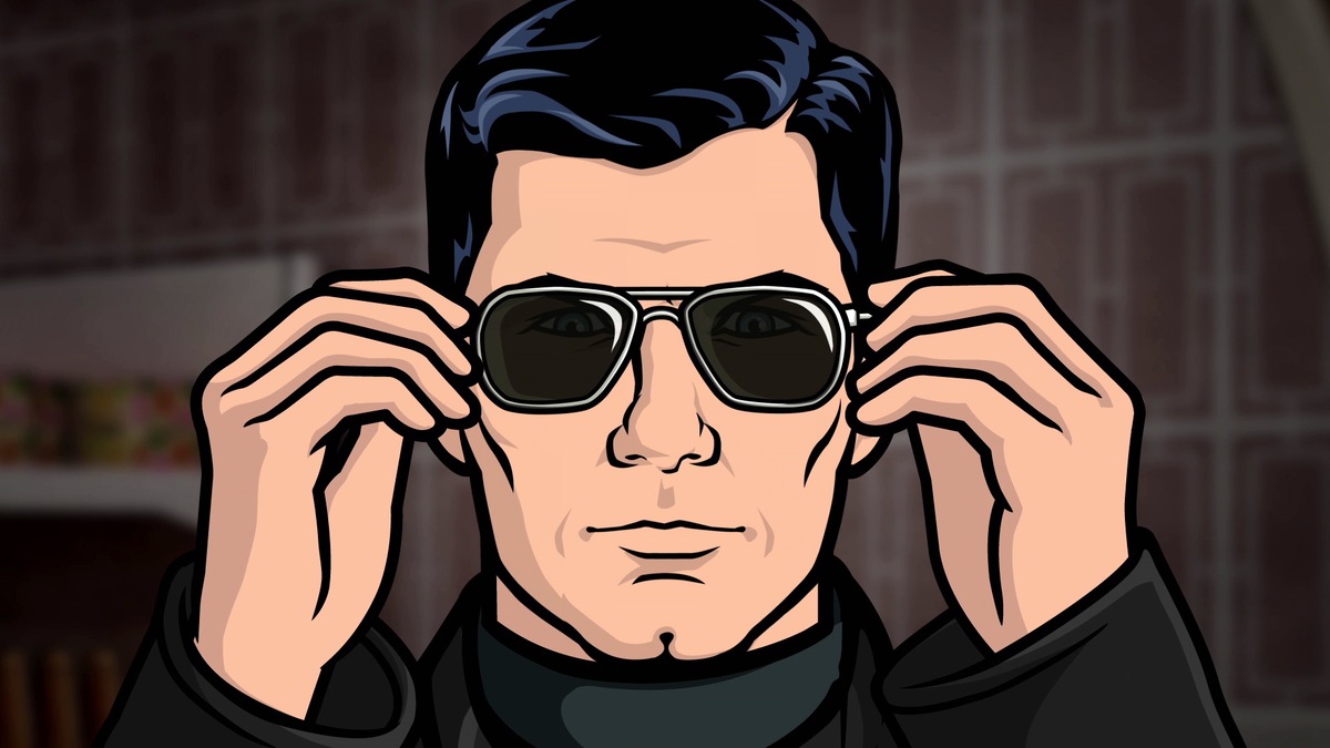 Archer from FX show putting on sunglasses in a dark suit