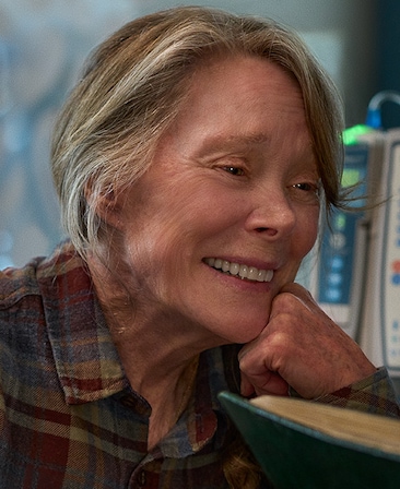 Headshot of Sissy Spacek playing Gail, wearing a plaid shirt in a hospital.