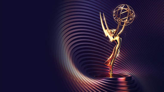 Emmy statue award with a swirling purple background