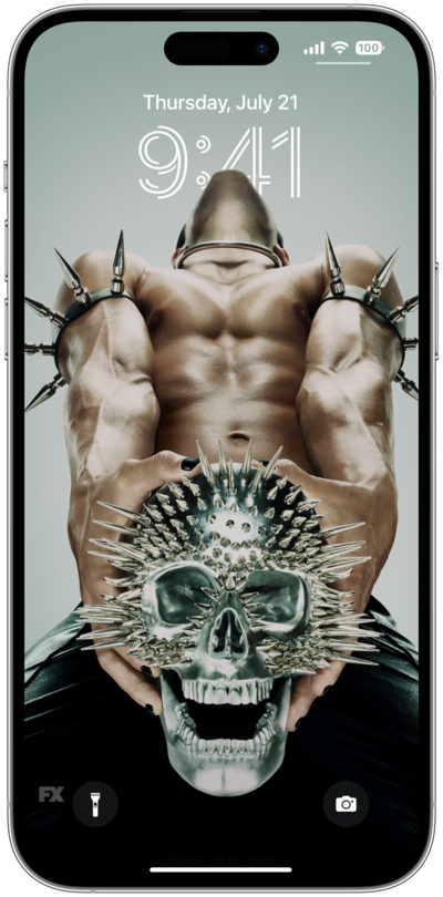 iPhone lock screen of man with black nail polish, black pants, and spikes on arms clenching spiked metal skull AHS NYC