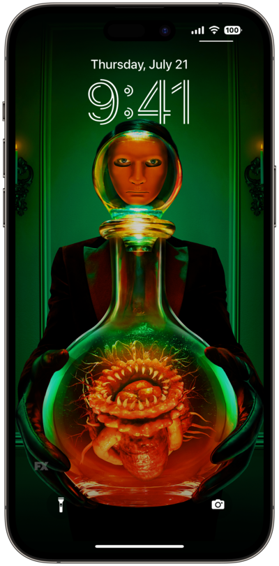 Person wearing a mask and black gloves, holding a vase with organs inside it
