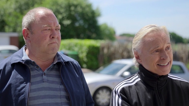 Dave and Dilip standing next to each other outside