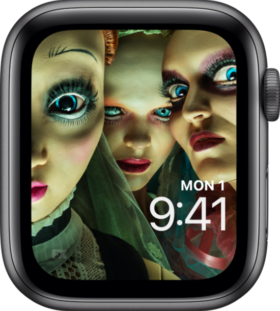 Apple Watch lock screen of wide-eyed dolls and colorful clothes and makeup from FX's American Horror Stories
