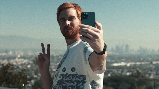 Mike from Dave FX show taking a selfie with a peace sign in front of LA skyline
