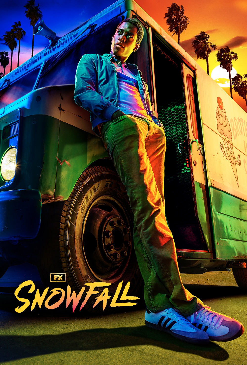Franklin Saint leaning on an ice cream truck against a split day-and-night sky backdrop with palm trees for FX's Snowfall.