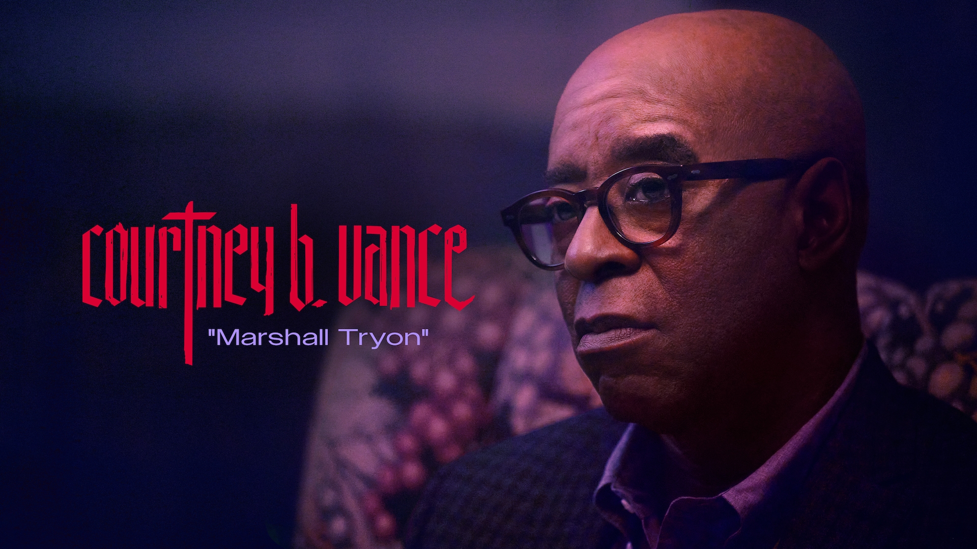 Courtney B. Vance as Marshall Tryon in FX's Grotesquerie in a suite wearing brown glasses sitting on a patterned couch.