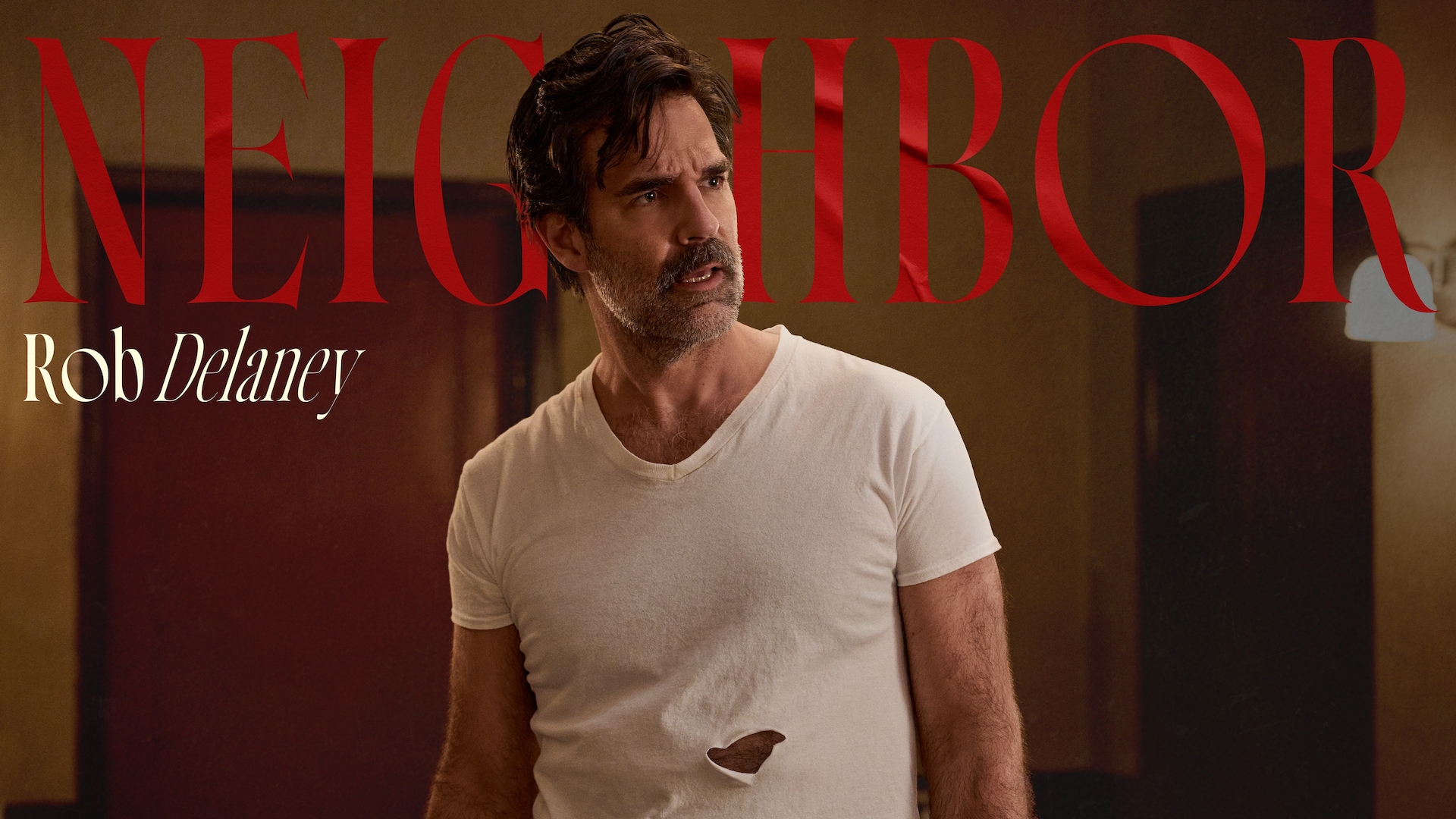 Rob Delaney as the Neighbor in FX's Dying For Sex, wearing a white shirt with a large hole in the abdomen area.