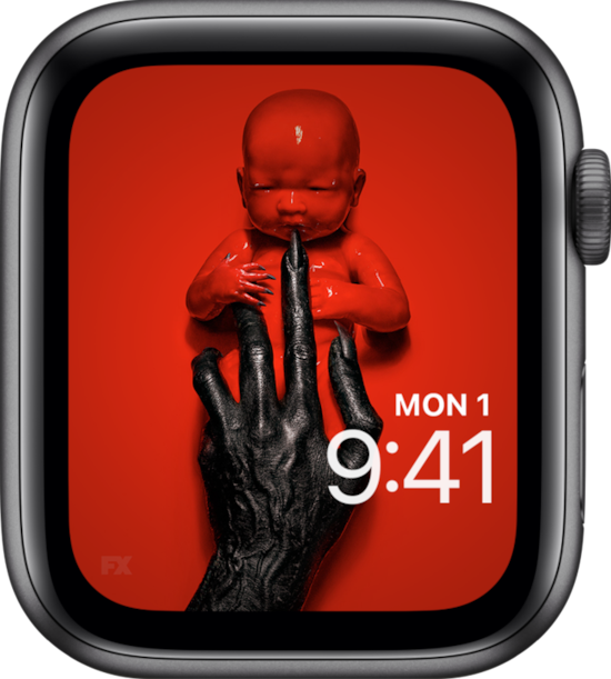 Apple Watch lock screen of red baby with black claws held by black hands American Horror Story 8 Apocalypse