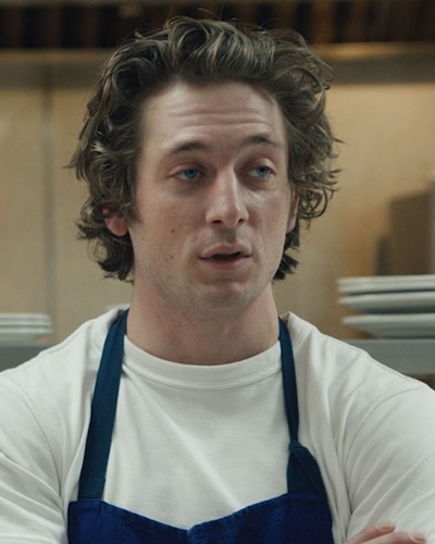 Carmy from The Bear FX show crossing his arms in the kitchen