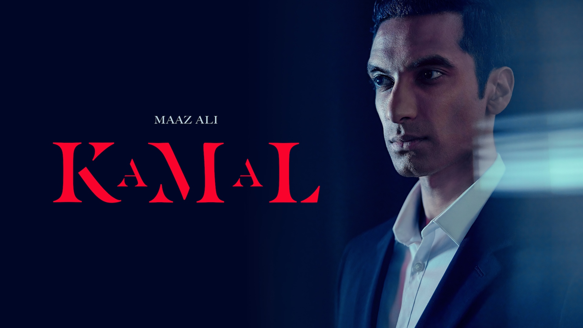 Maaz Ali headshot wearing a white shirt and suit jacket standing in a dark setting for AHS: Delicate