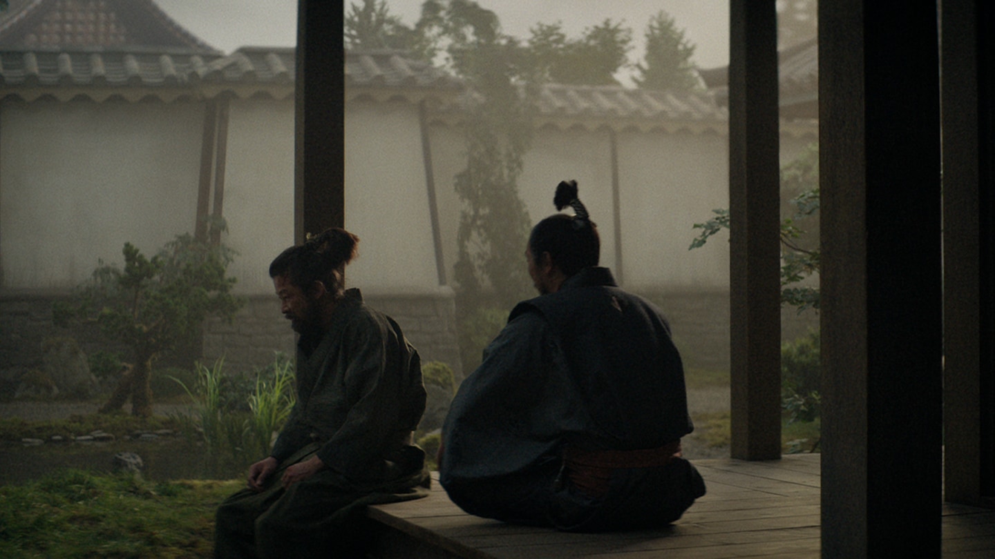 Ishido and Yabushige sitting in the courtyard garden