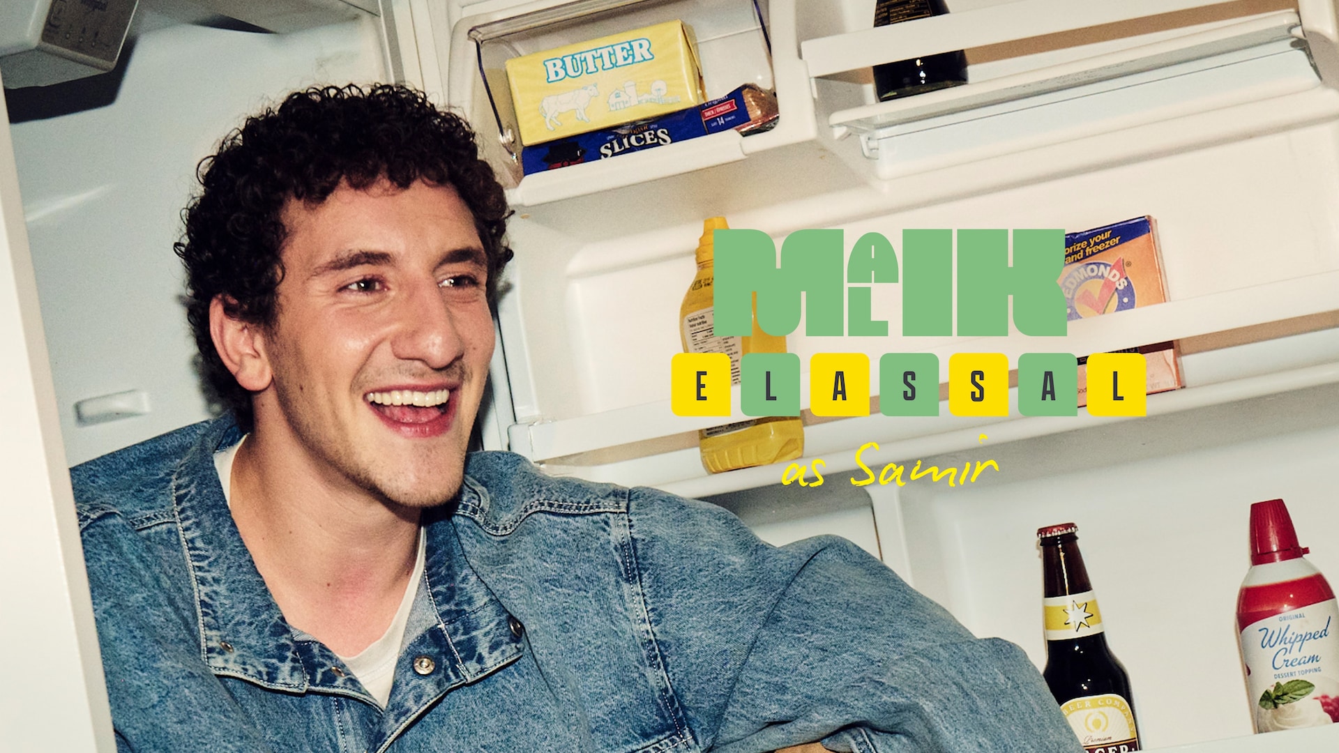 Malik Elassal as Samir FX's Adults wearing a denim jacket siting inside of a used fridge.