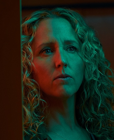 Brooke Smith with blonde curly hair captured in green lighting for FX's Class of '09