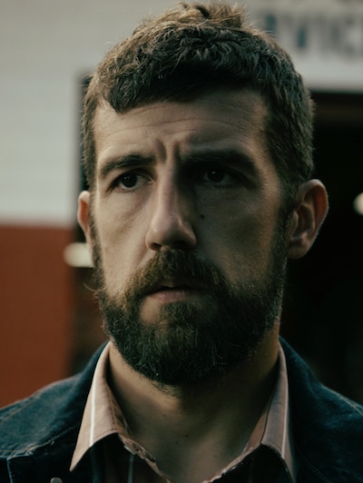 Teddy from FX's Snowfall with a serious expression on his face
