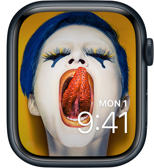 Apple Watch lock screen of blue haired woman against yellow background licking lips with holed tongue from FX's AHS Cult