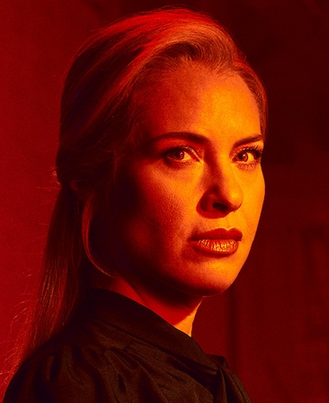 Headshot of Leslie Grossman in black shirt with red lighting on face